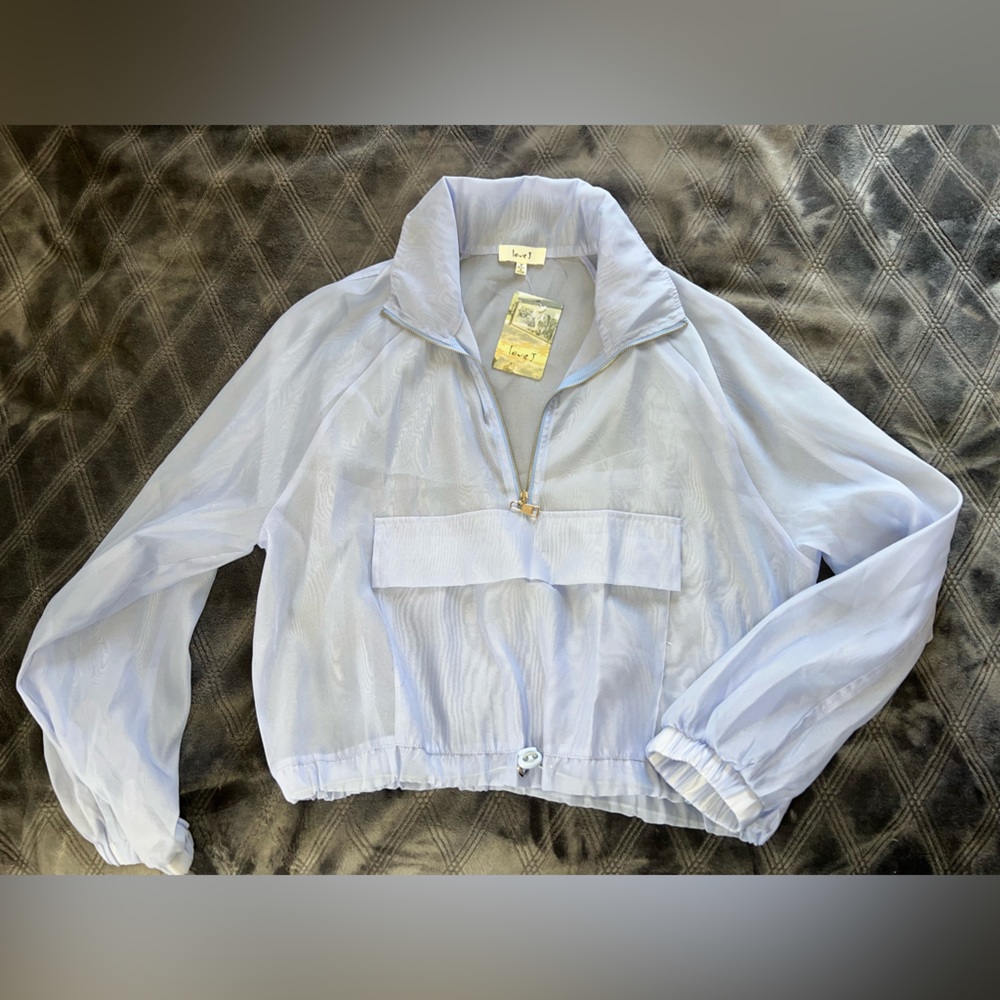 Organza lilac windbreaker top with drawstring hem with toggle.